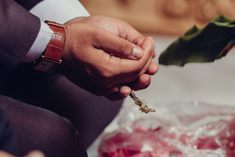 a close up of a person holding a flower