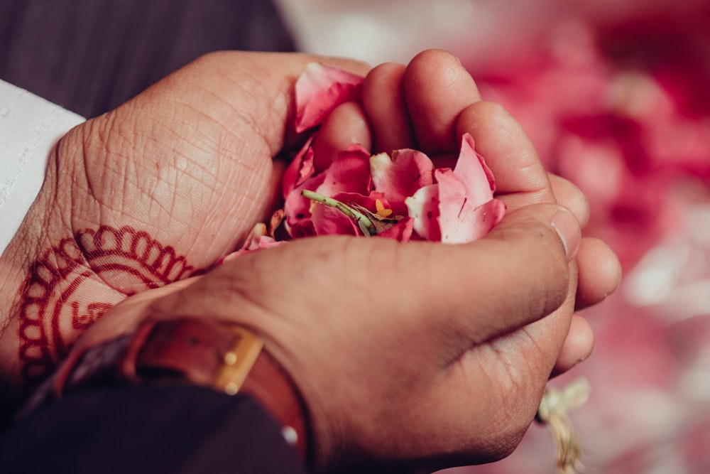 a close up of a person holding a flower