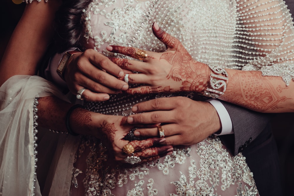 a close up of a bride and groom holding each other