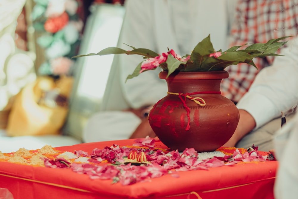 a vase with flowers sitting on a table