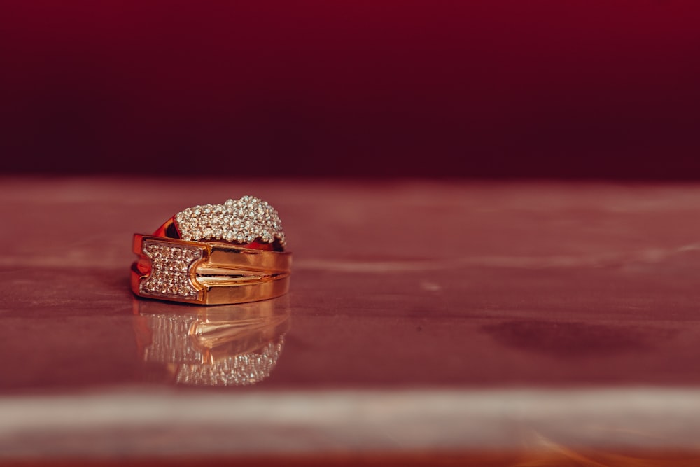 a couple of gold rings sitting on top of a table