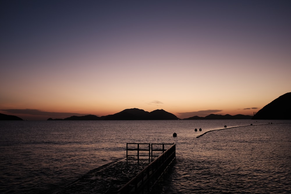 a long dock in the middle of a body of water