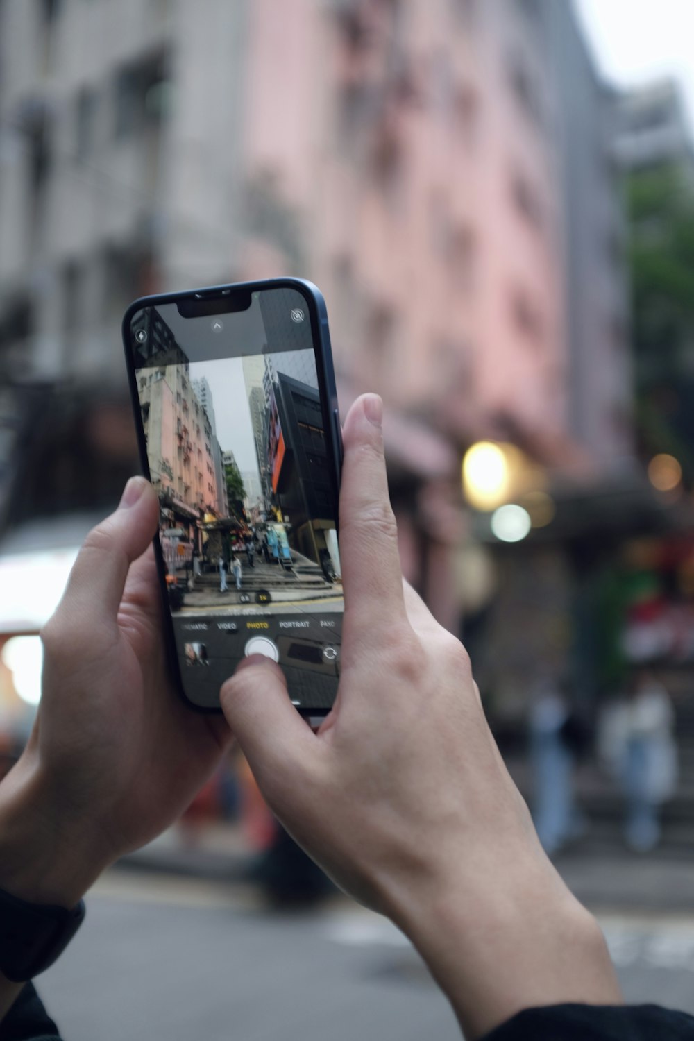 a person taking a picture of a street with a cell phone