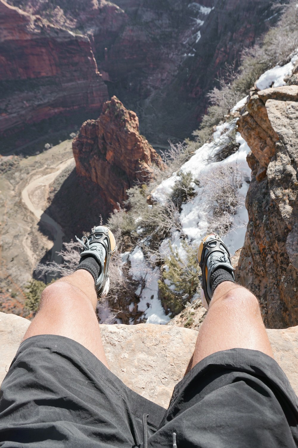 a person with their feet up on a cliff