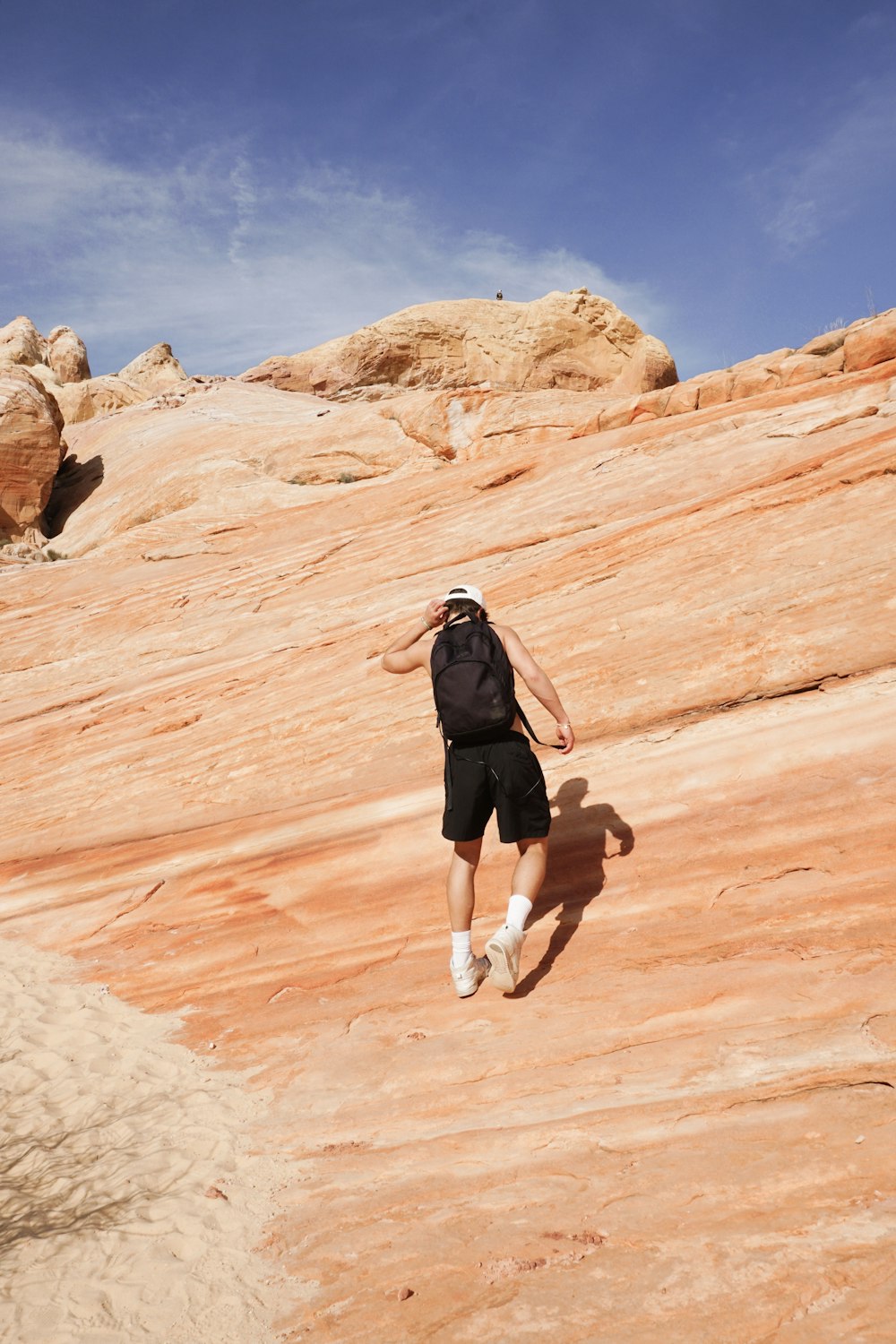 a man in black shirt and shorts playing frisbee