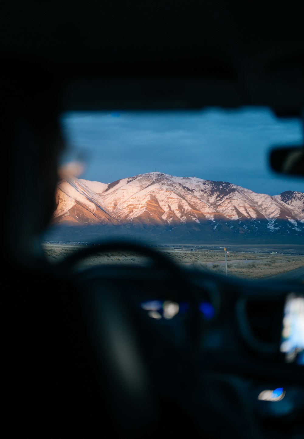 a view of the mountains from inside a car
