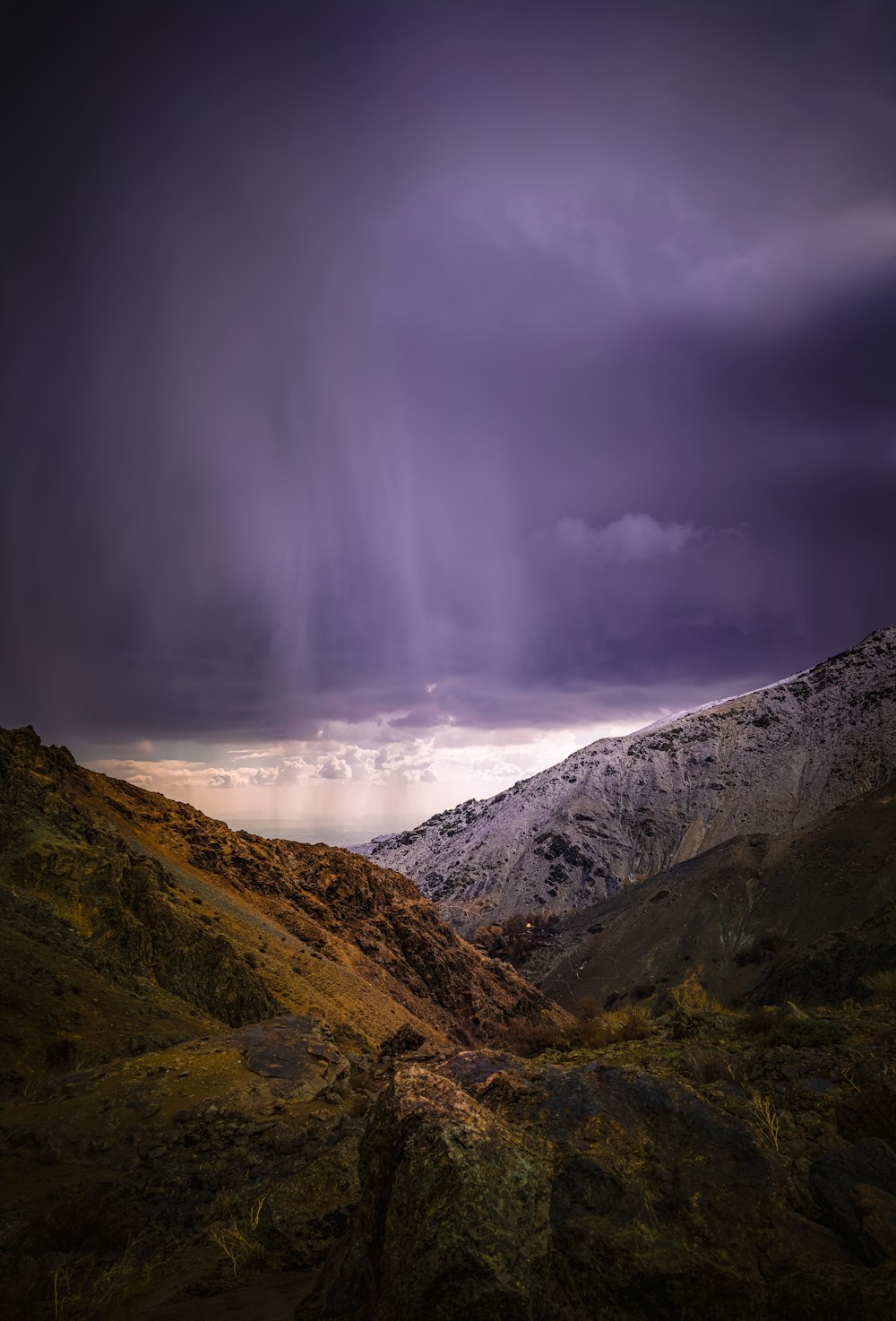 a mountain with a very dark sky in the background