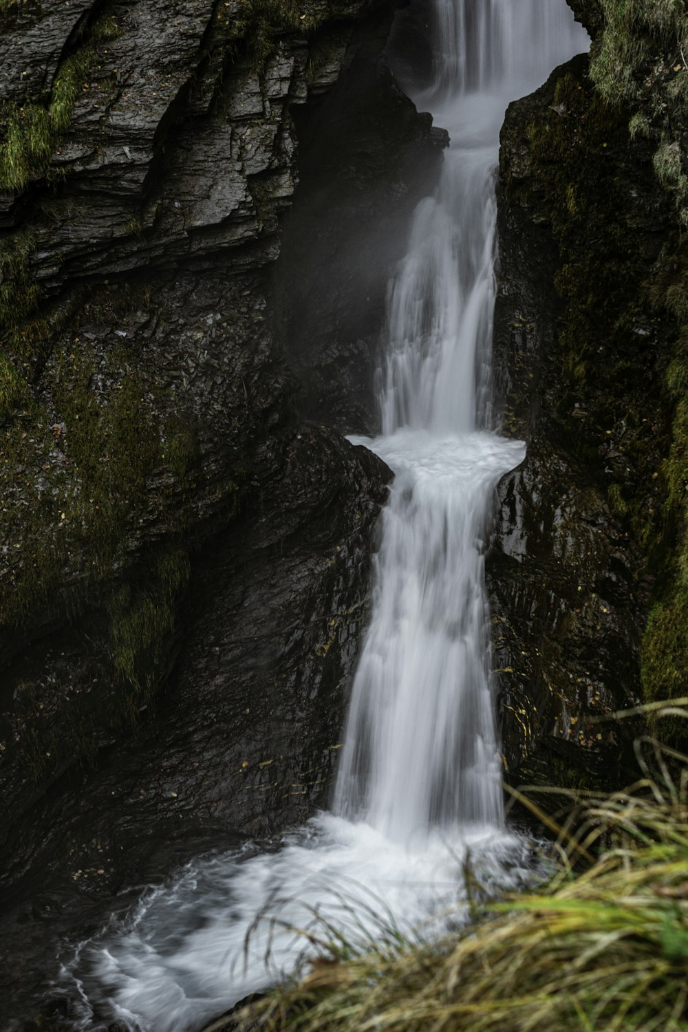 a waterfall with water cascading down the side of it