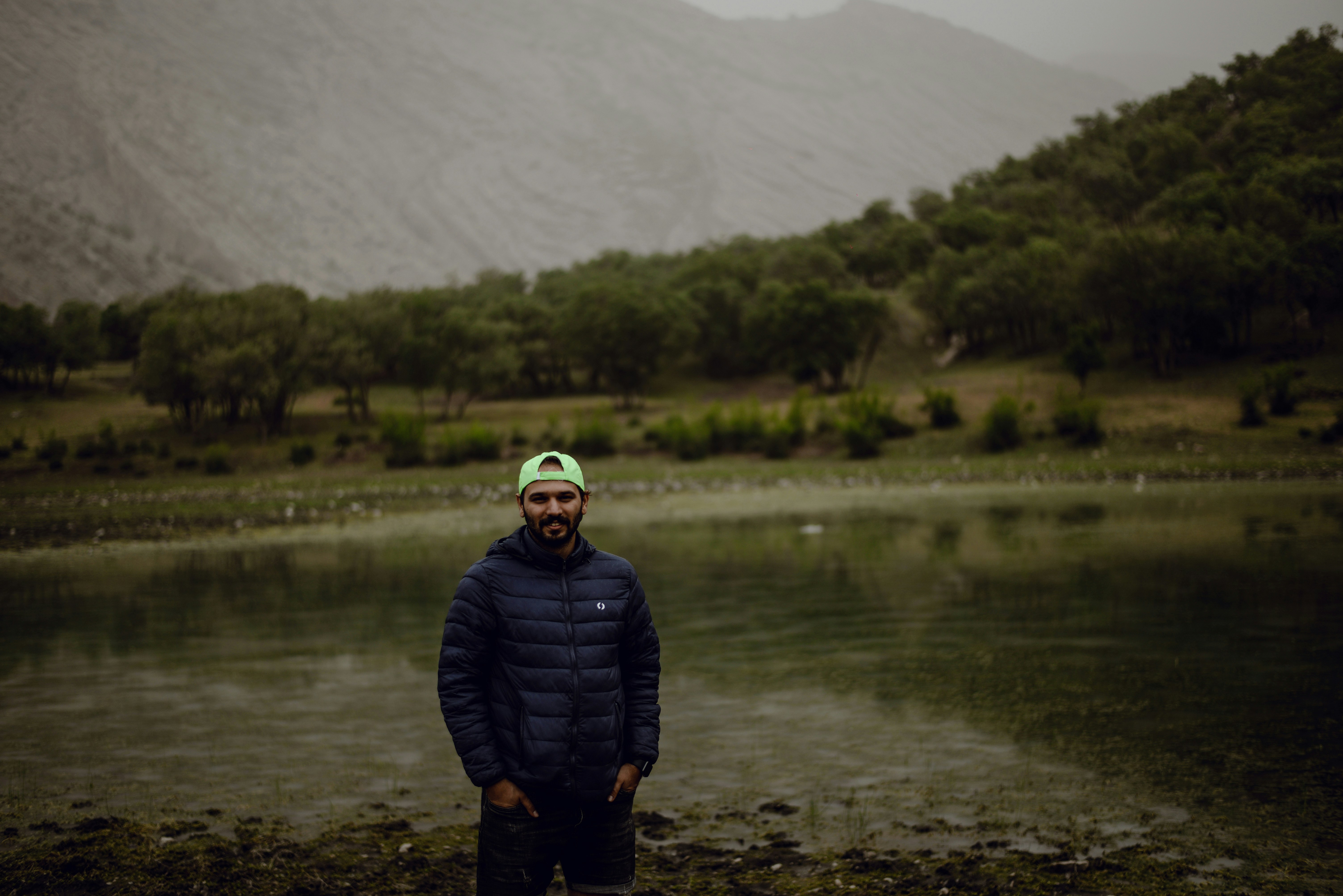 a man standing in front of a body of water