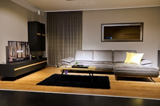 a living room filled with furniture and a flat screen tv