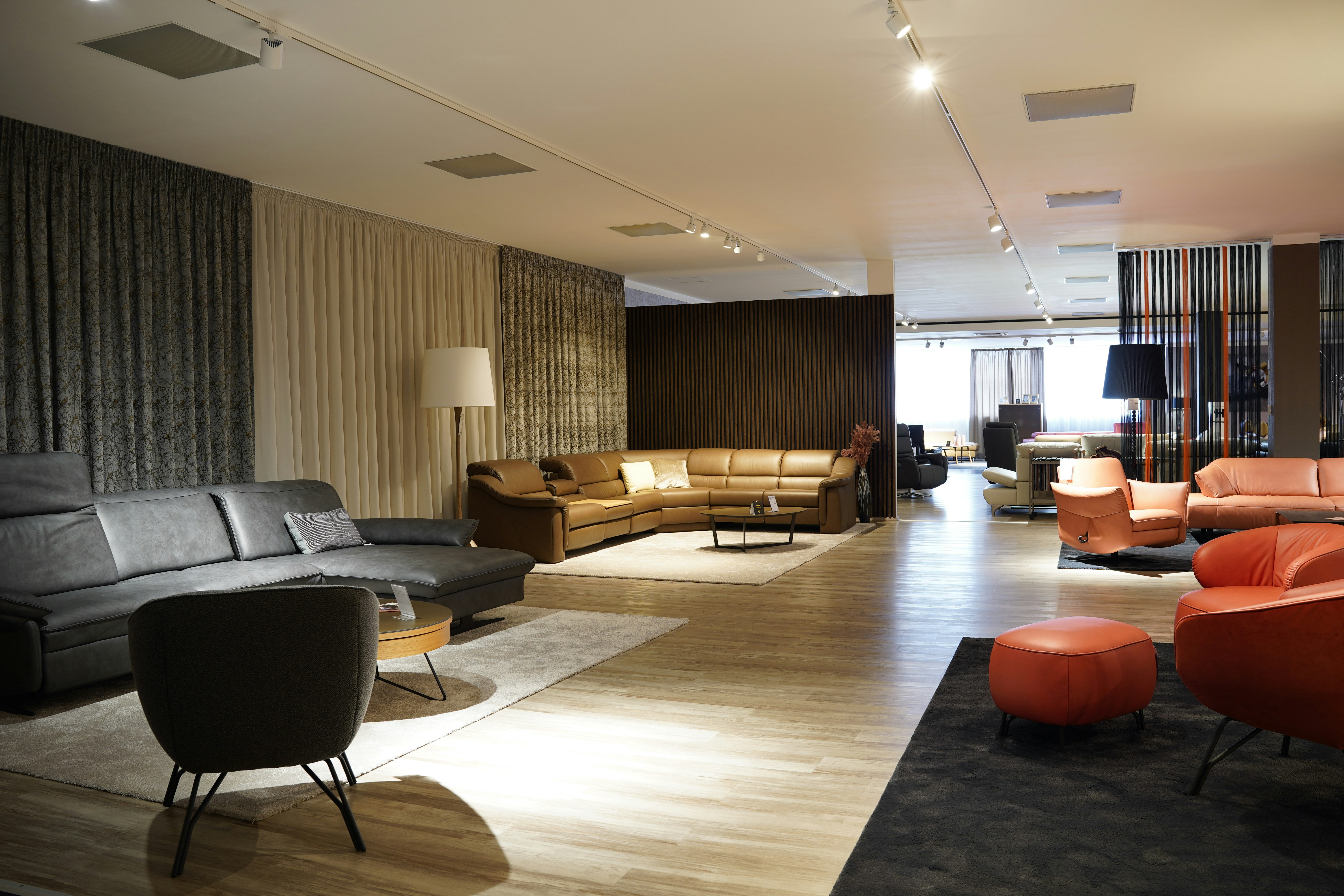 a living room filled with lots of furniture, colorful couches, and styles for different living rooms