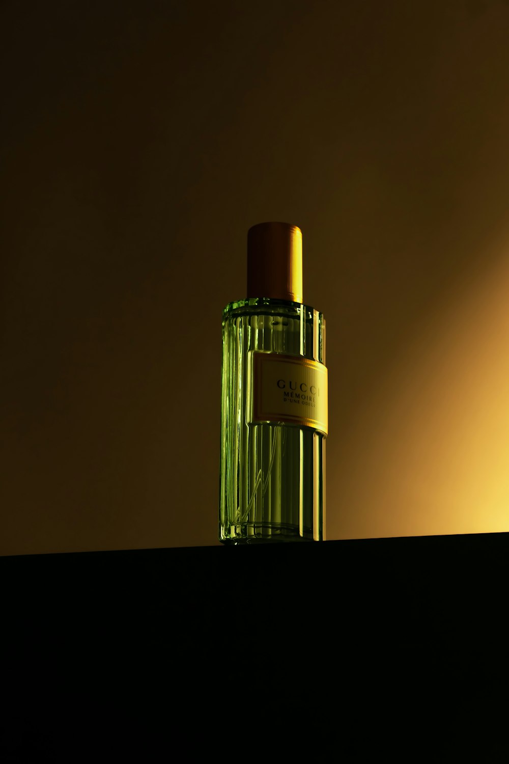 a bottle of perfume sitting on top of a shelf
