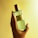 A happy customer holding a bottle of Omer Farooq perfume.