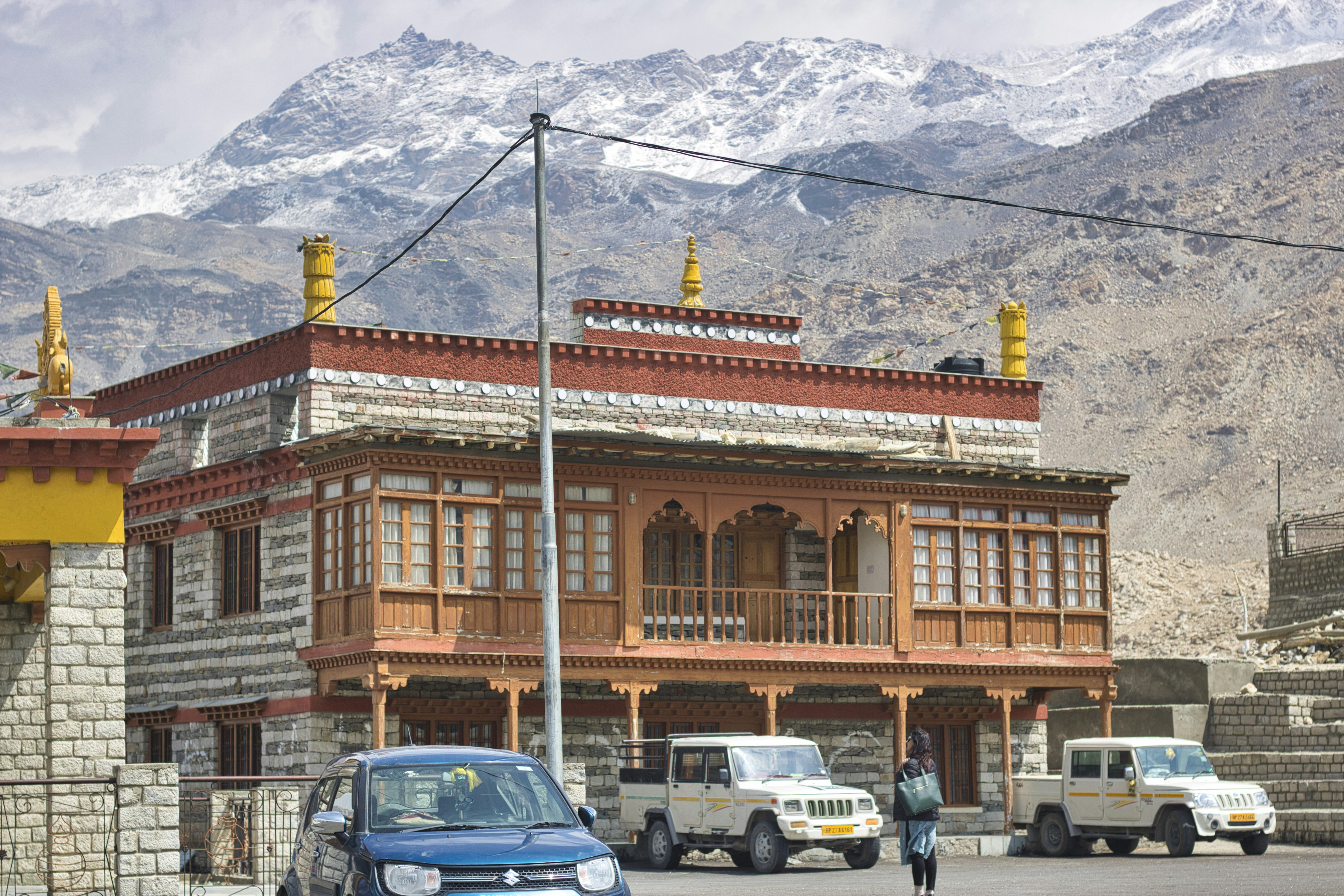 a blue car is parked in front of a building