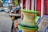 A vibrant vegetable market scene with colorful plastic baskets stacked neatly.