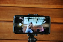 a person taking a picture of a person on a cell phone