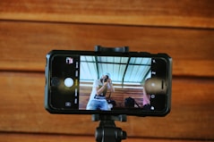 a person taking a picture of a person on a cell phone