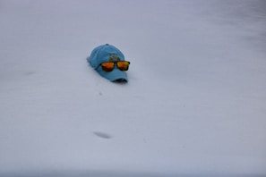 A stylish cap embroidered with a personalized name and colorful design, worn outdoors.