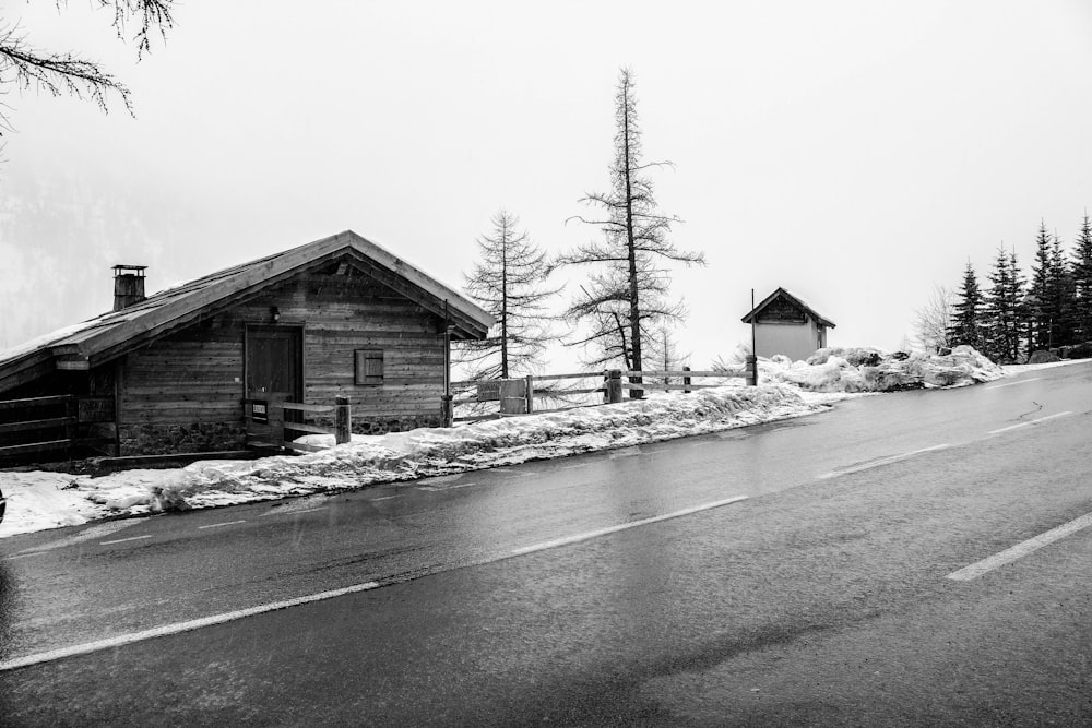 a black and white photo of a snowy road