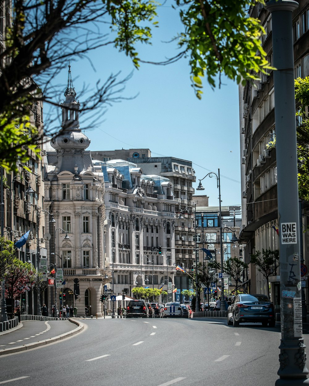 a city street with a large building in the background