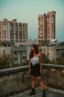 A sleek urban outfit displayed on a modern city rooftop at sunset.