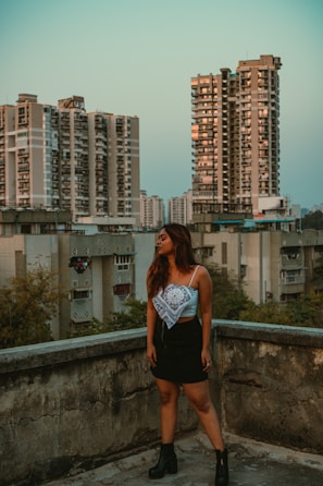 A sleek urban outfit displayed on a modern city rooftop at sunset.