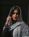a woman in a veil smoking a cigarette