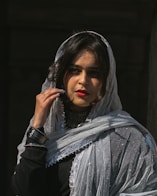 a woman in a veil smoking a cigarette