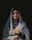 a woman wearing a veil and holding a purse