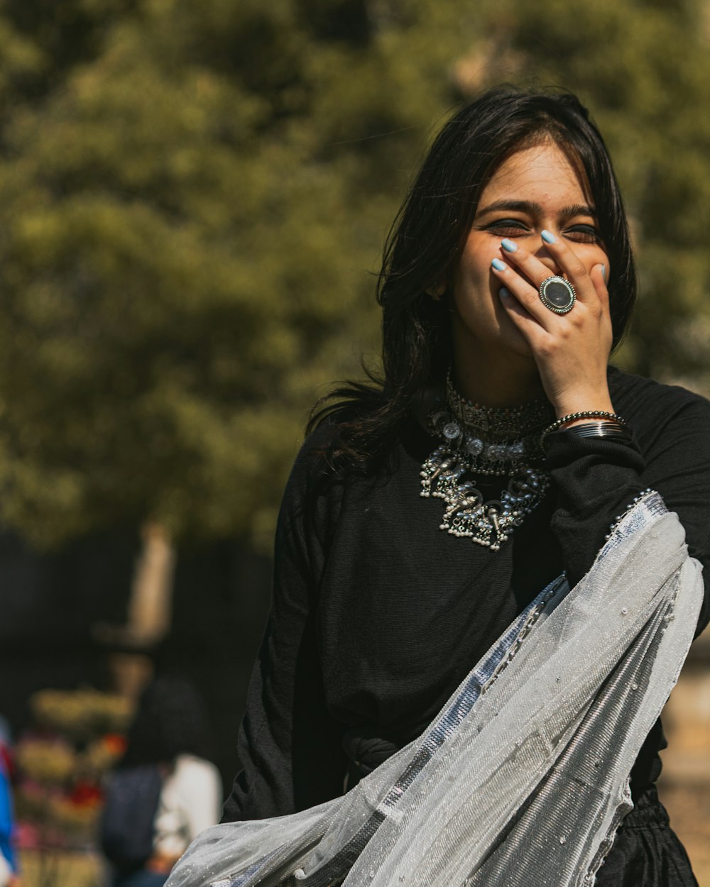 a woman talking on a cell phone while wearing a veil