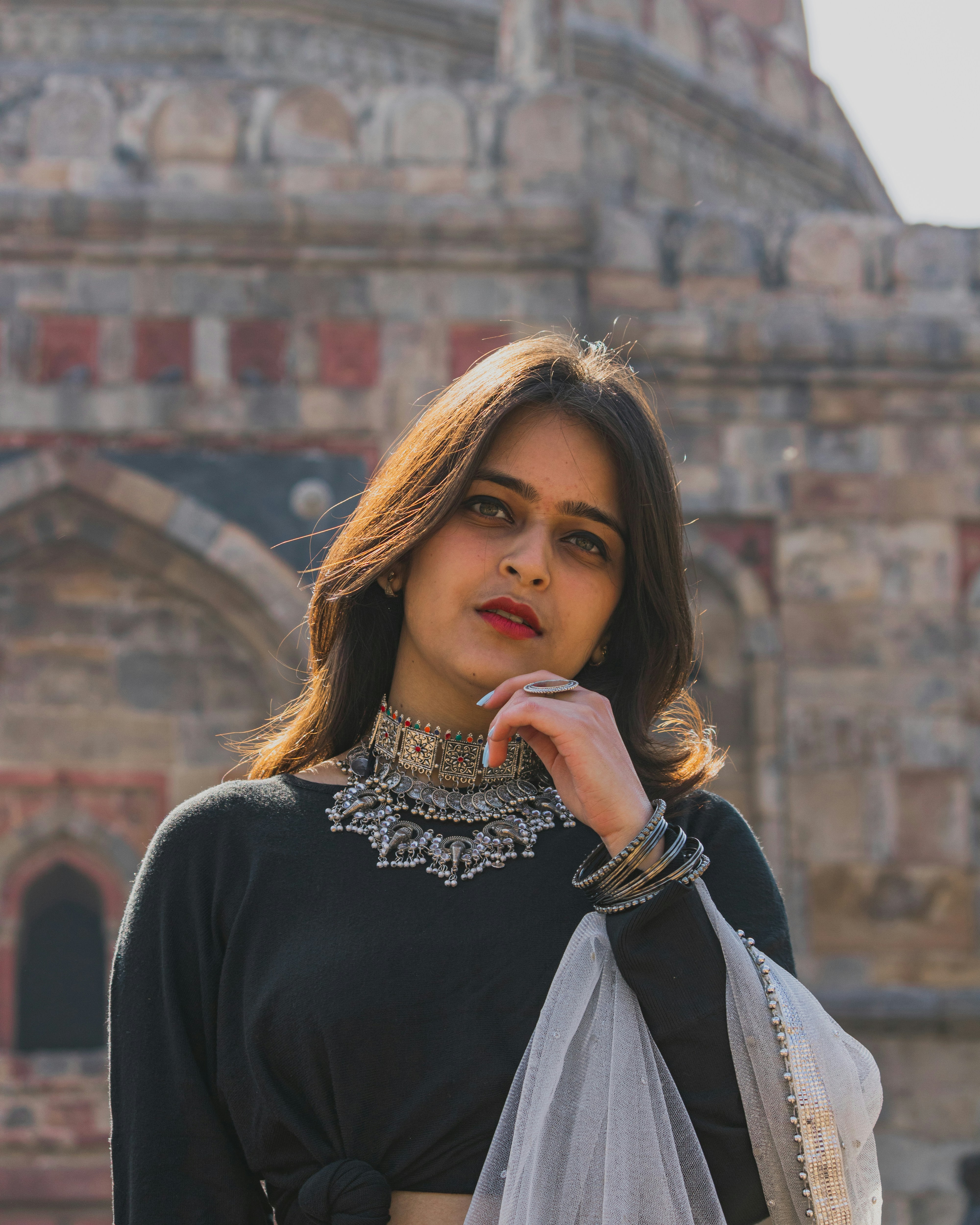 a woman standing in front of an old building