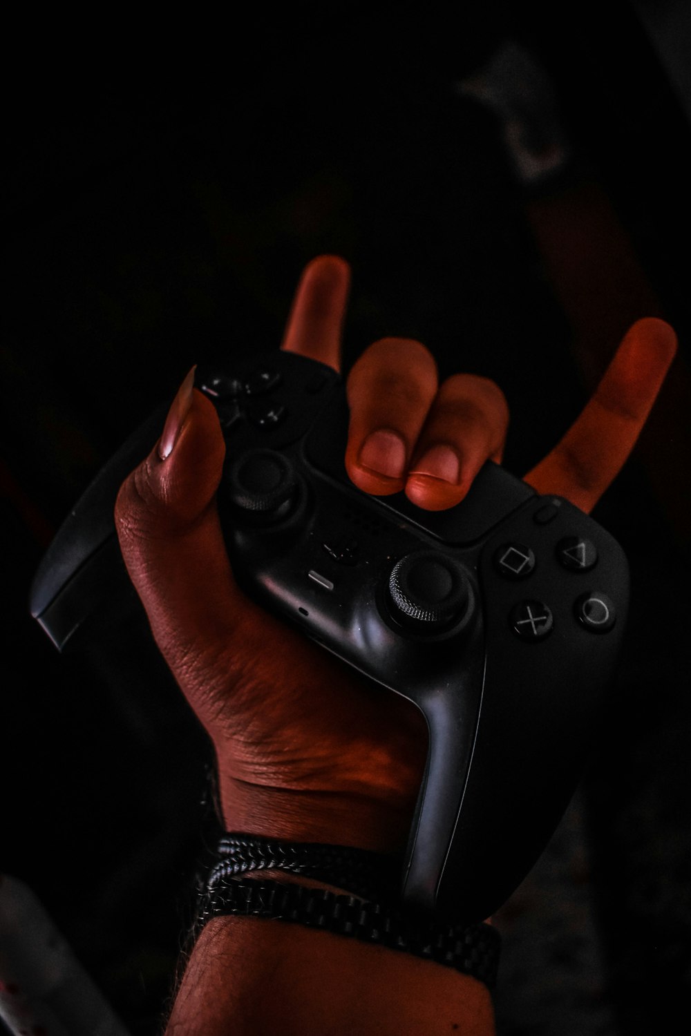 a person holding a video game controller in their hand