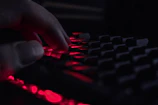 A digital neon keyboard with fingers poised to send a perfectly awkward but clever text reply.