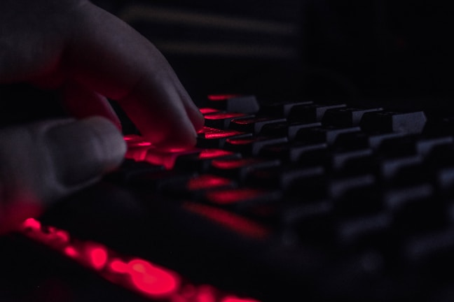 A close-up of hands typing on a keyboard with soft natural light.