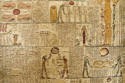 An ancient Egyptian numeral chart with symbols and hieroglyphs displayed on a parchment.
