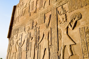 a large wall with a bunch of egyptian art on it