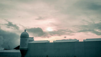 Warm photograph of the Baluarte de Santiago at sunset with soft golden light.