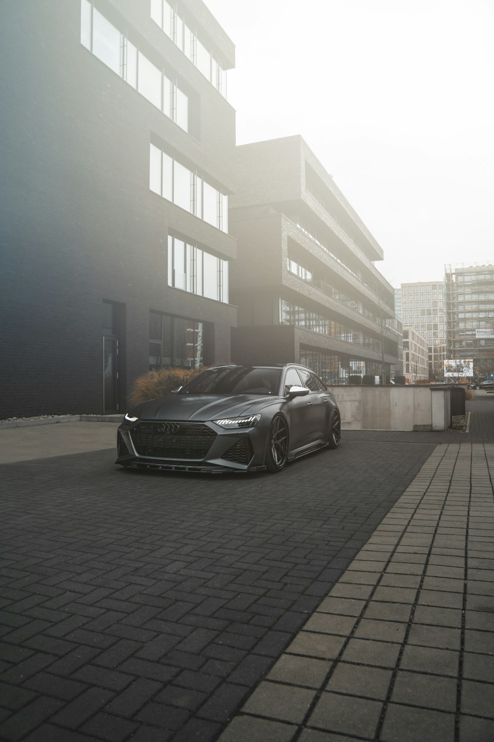 a black sports car parked in front of a building