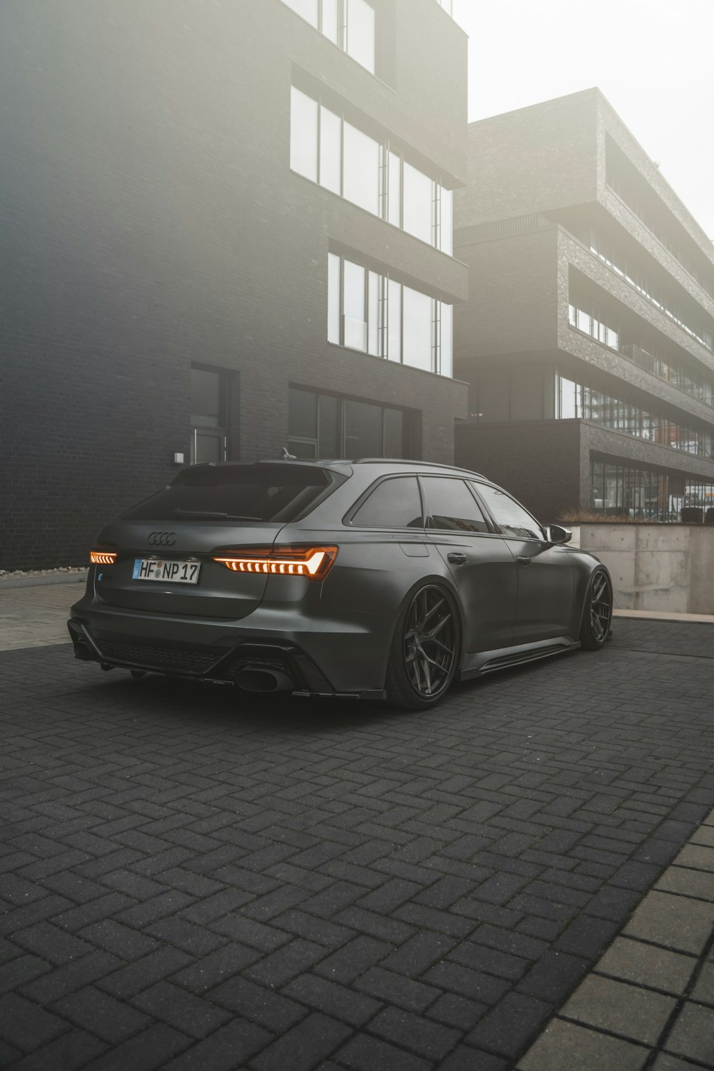 a grey car parked in front of a building