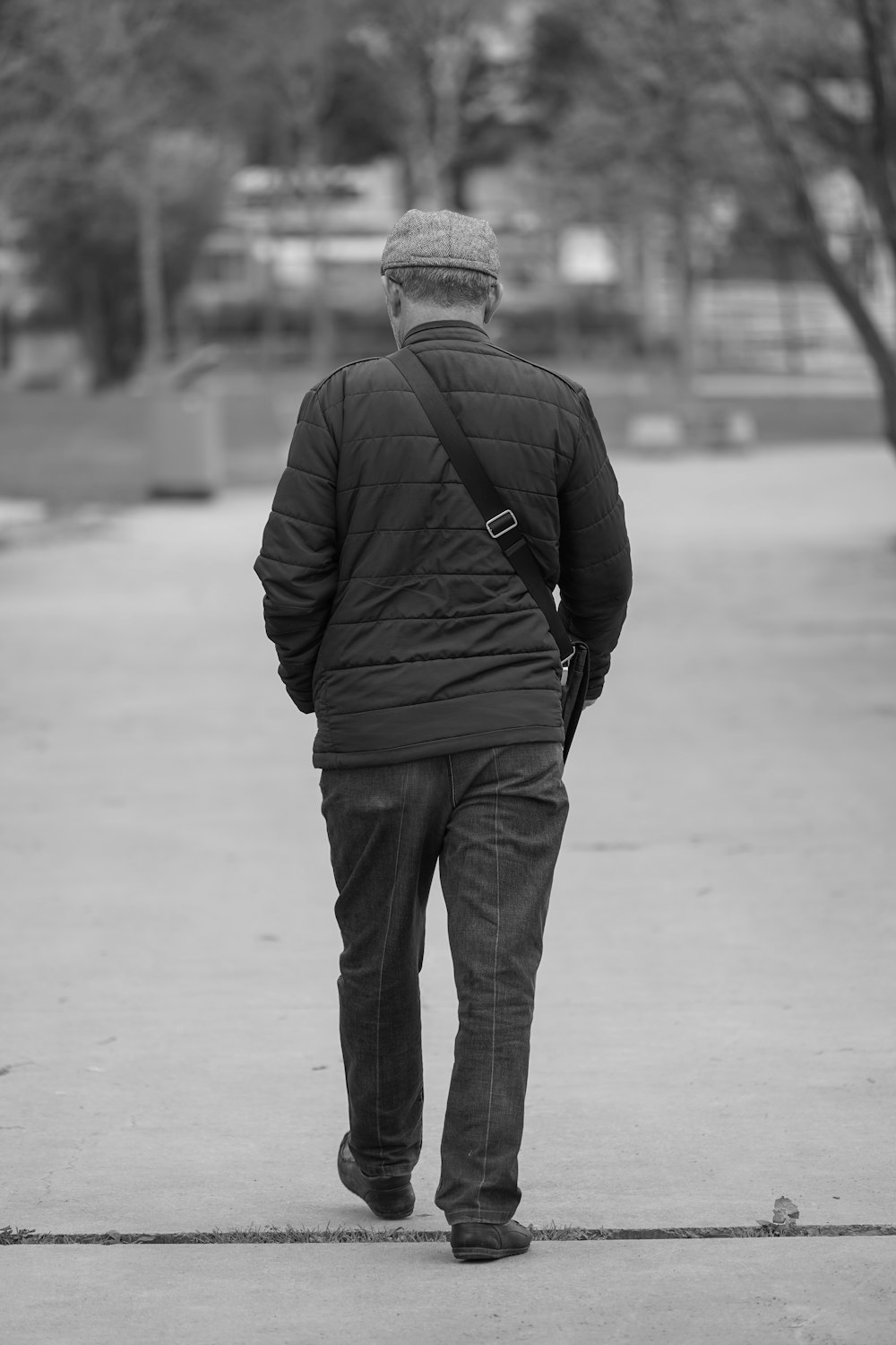 a black and white photo of a man walking