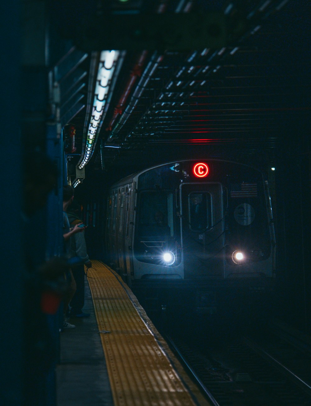 a train is coming down the tracks at night