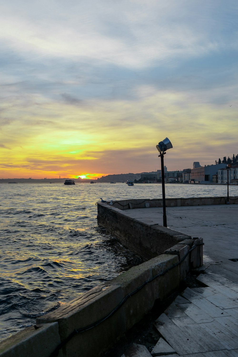 the sun is setting over a body of water