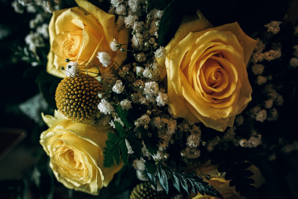 a bouquet of yellow roses and baby's breath