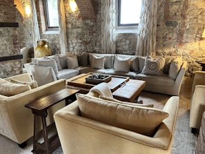 Elegant living room corner with large, natural stone tiles creating a cozy atmosphere