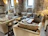 A cozy living room featuring elegant natural stone finishes with warm lighting.