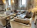 A cozy living room featuring elegant natural stone finishes with warm lighting.