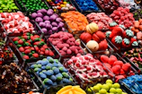Colorful assortment of freeze-dried candies arranged on a sleek black surface with cosmic neon reflections.