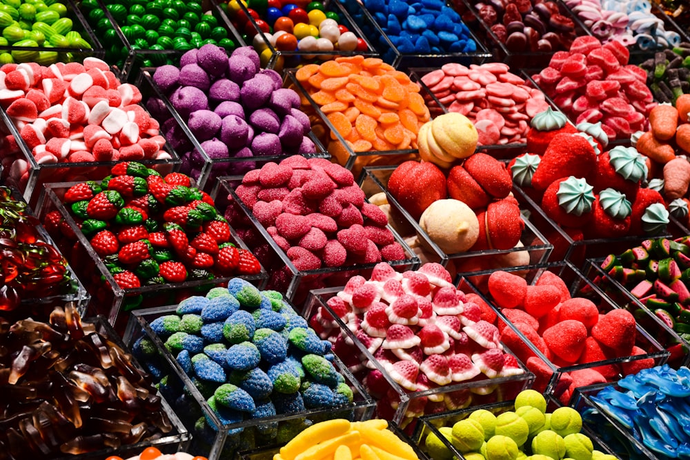 a bunch of different colored candies on display