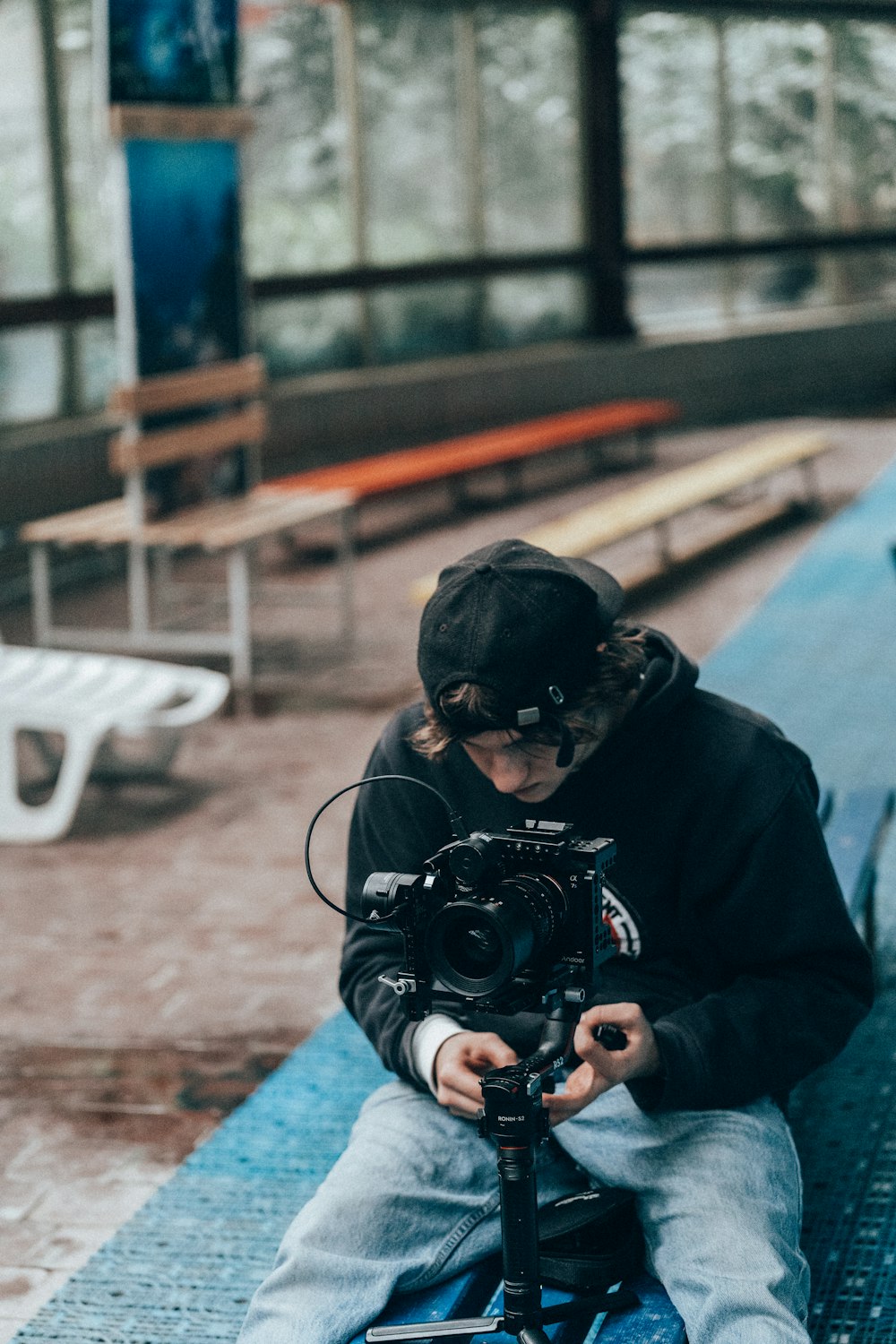 a person sitting on a bench with a camera