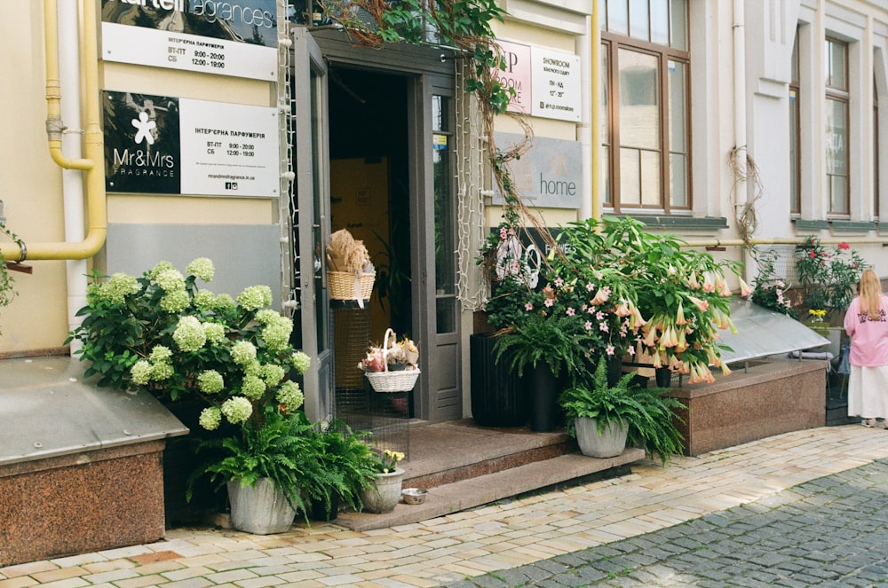 a little girl standing outside of a flower shop